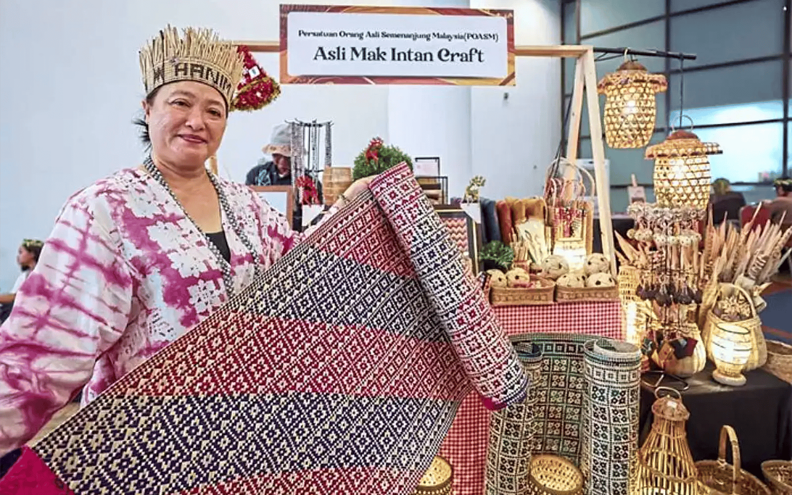 A Malaysian artisan with woven craft pieces